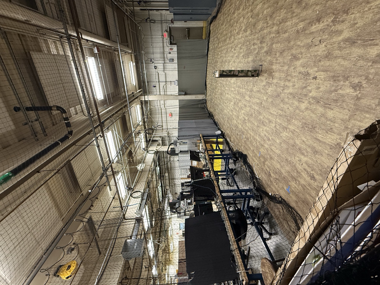 Wide view of the FRC 467 team shop with workbenches and netting