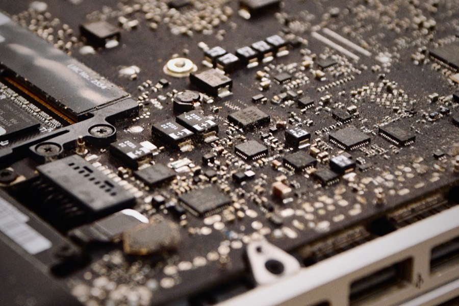 Macro photograph of a laptop logic board covered in surface-mount components