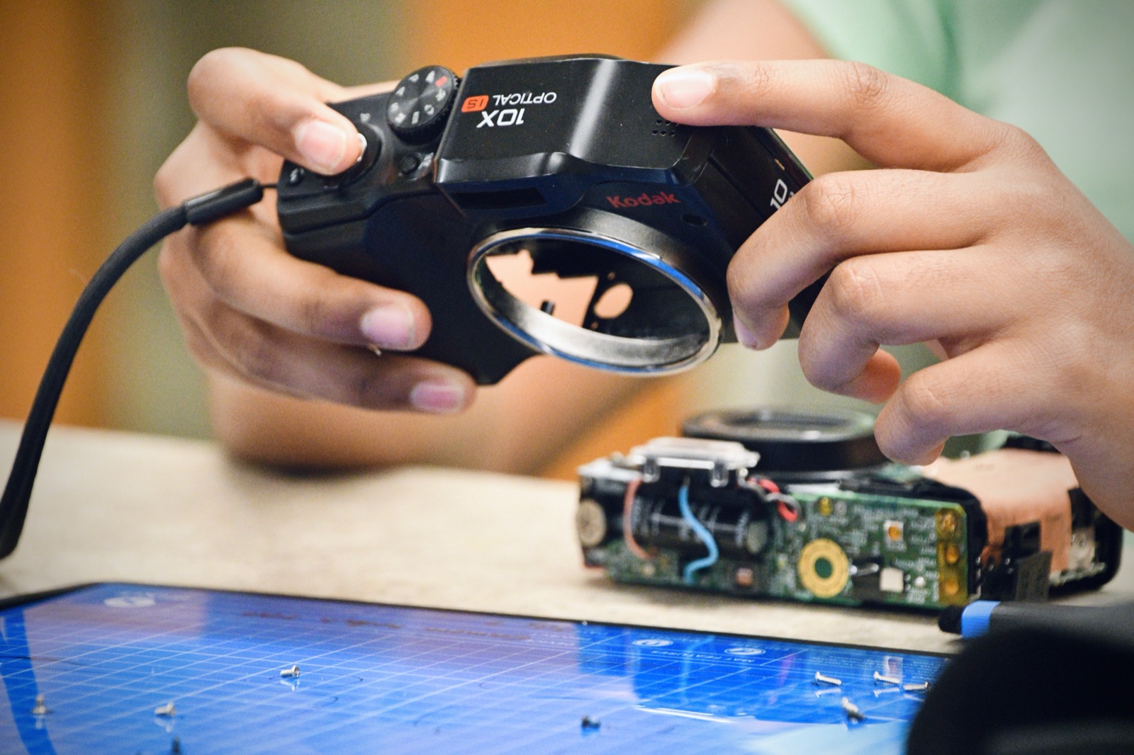 A point-and-shoot camera opened down to its logic board