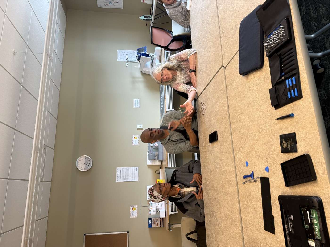 TAA volunteers walking seniors through their devices at Southgate Senior Center